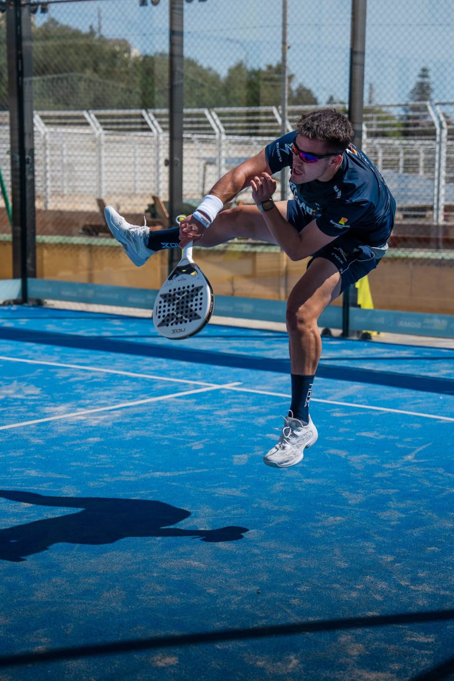 Player smashing the ball on the Pembroke court
